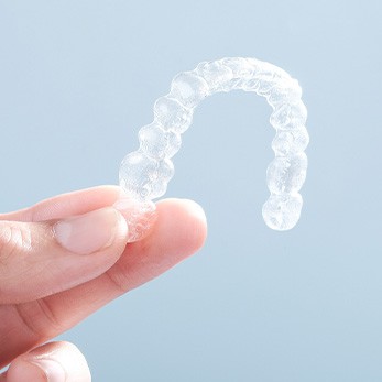 Patient holding clear aligner