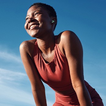 Woman smiling while exercising outside