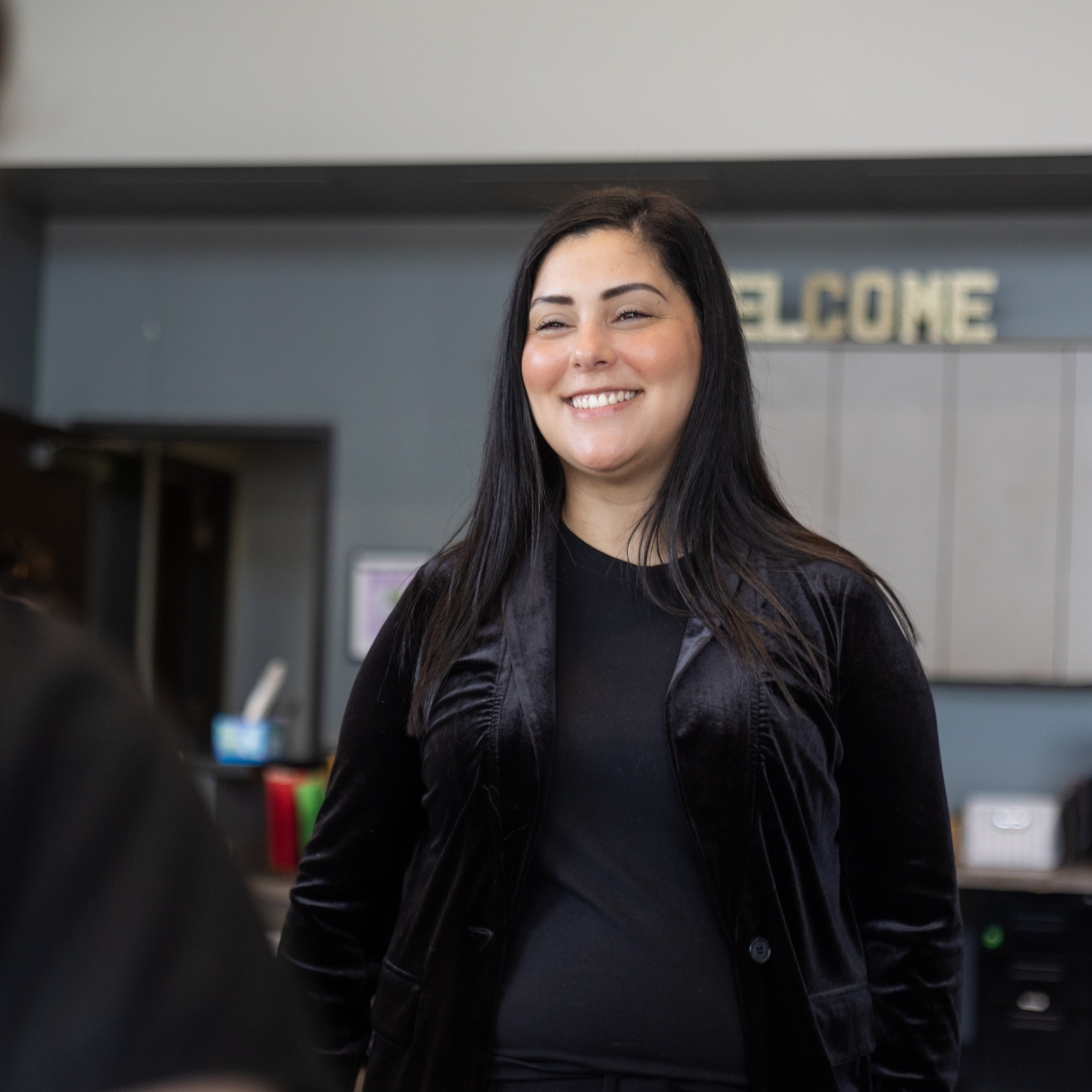 Woman in black shirt smiling in dental office