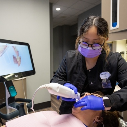 Dental team member taking digital impression of patients mouth