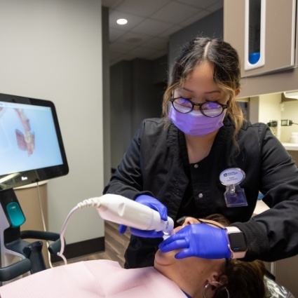 Dentist taking digital impression of patients teeth