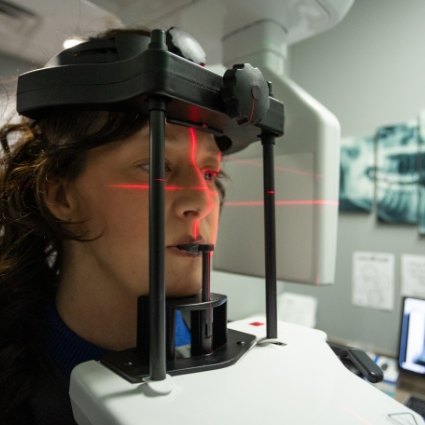 Dental patient having scan taken by cone beam scanner