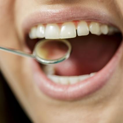 Close up of dental mirror and teeth