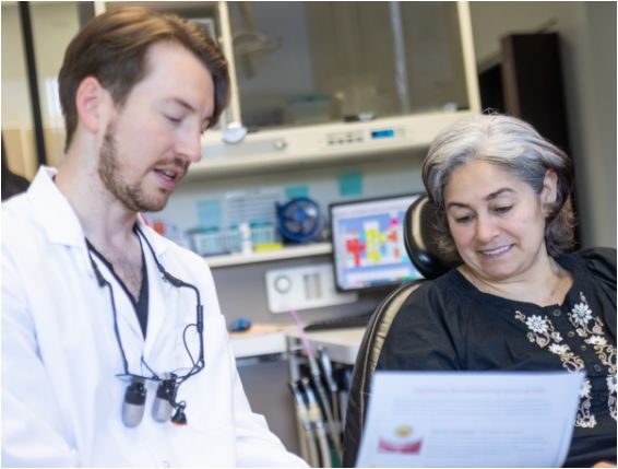 Dentist showing patient a piece of paper