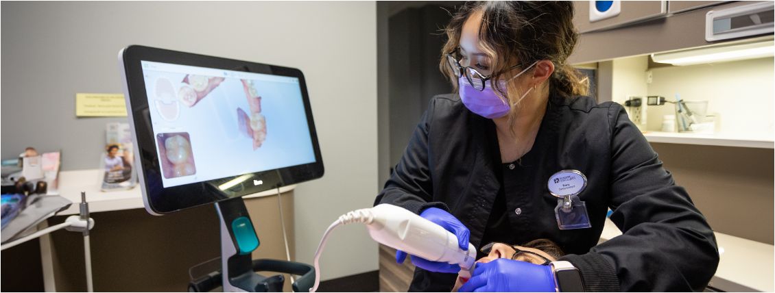 Female dental team member scanning patients mouth