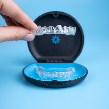 Close up of hand putting aligners in case