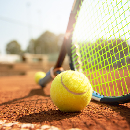 Close up of tennis balls and a tennis racket