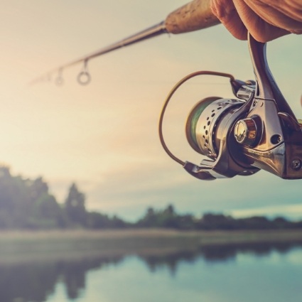 Close up of fishing rod over lake