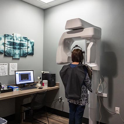 Woman having dental x ray taken in Rogers dental office