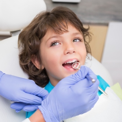 Child having teeth examined by dentist