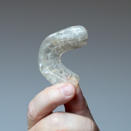 Hand holding nightguard for bruxism