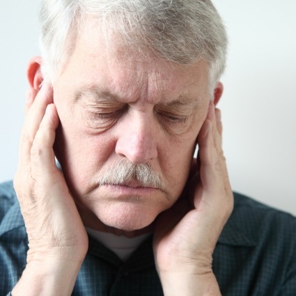 Man rubbing jaw joints due to jaw pain